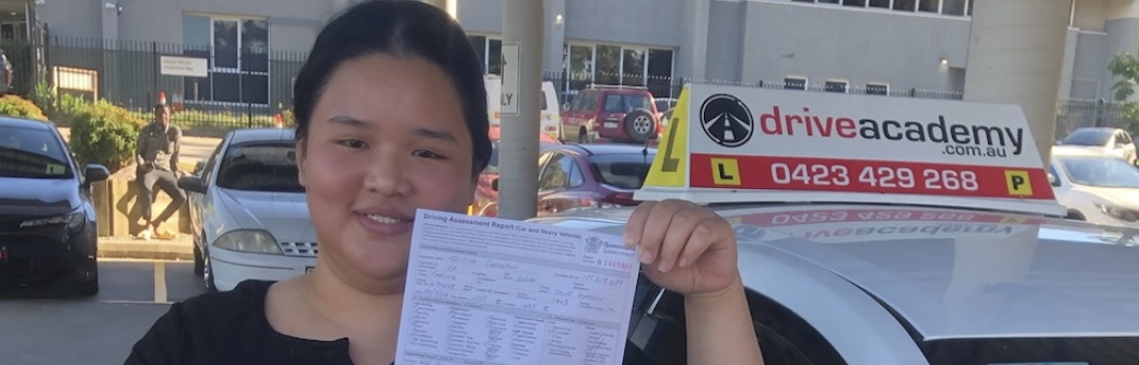 Student holding licence after test